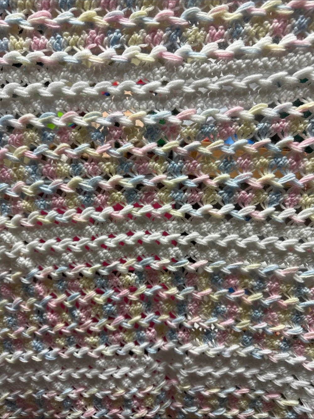 White Crochet Baby Throw with Pastel Pink, Blue, and Yellow Accents
